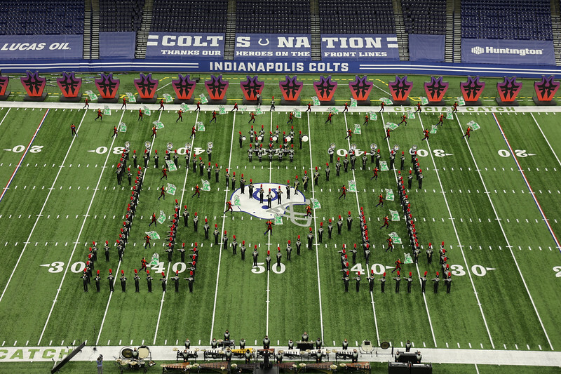 group in form of M on football field